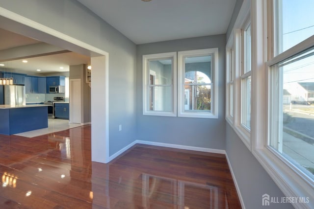 unfurnished room featuring dark hardwood / wood-style flooring