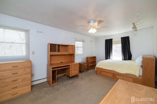 bedroom with ceiling fan, light colored carpet, and baseboard heating