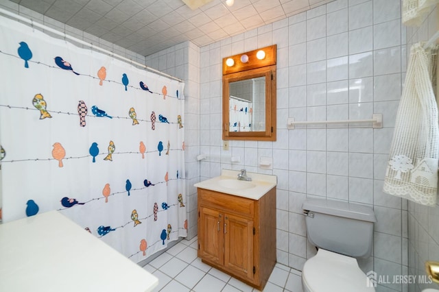 bathroom with tile patterned flooring, vanity, toilet, tile walls, and a shower with curtain