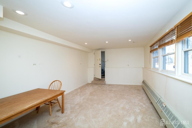 spare room with light carpet, a baseboard heating unit, and recessed lighting
