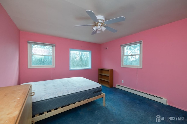bedroom with ceiling fan, carpet, and a baseboard heating unit