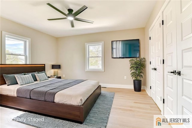32 Campbell Ave, Edison, NJ 08817 - bedroom featuring multiple windows, light wood-type flooring, baseboards, and a closet