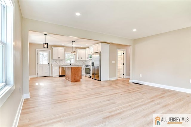 32 Campbell Ave, Edison, NJ 08817 - kitchen featuring stainless steel appliances, open floor plan, a center island, light countertops, and tasteful backsplash