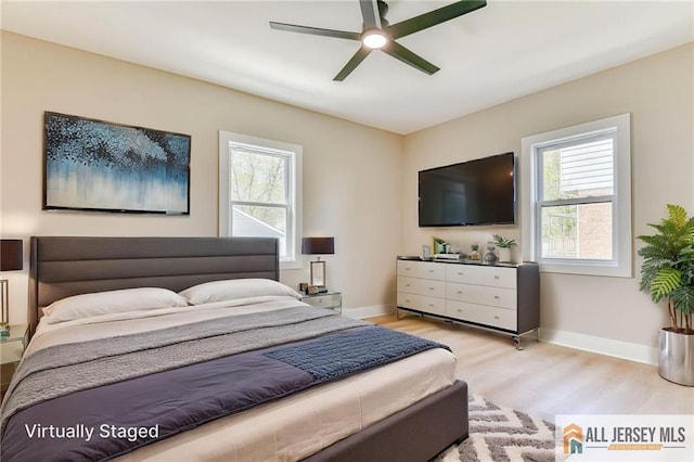 32 Campbell Ave, Edison, NJ 08817 - bedroom with light wood-type flooring, multiple windows, and baseboards