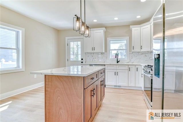 32 Campbell Ave, Edison, NJ 08817 - kitchen featuring stainless steel fridge, range with gas stovetop, tasteful backsplash, light stone countertops, and a sink