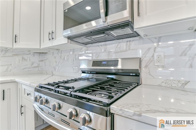 32 Campbell Ave, Edison, NJ 08817 - kitchen with stainless steel appliances, white cabinetry, backsplash, and light stone counters