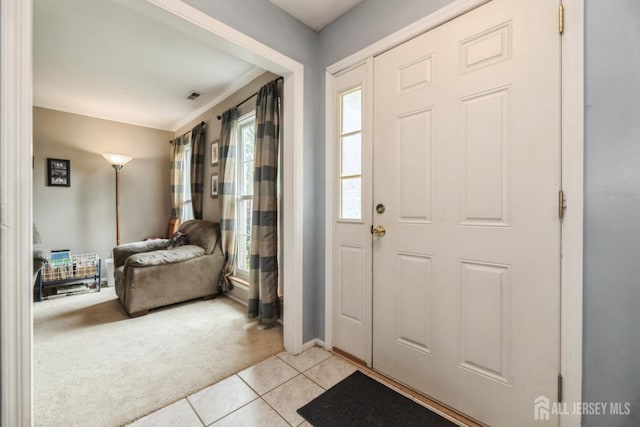 3 Pond View Dr, Plainsboro, NJ 08536 - foyer with light colored carpet, light tile patterned flooring, ornamental molding, and baseboards