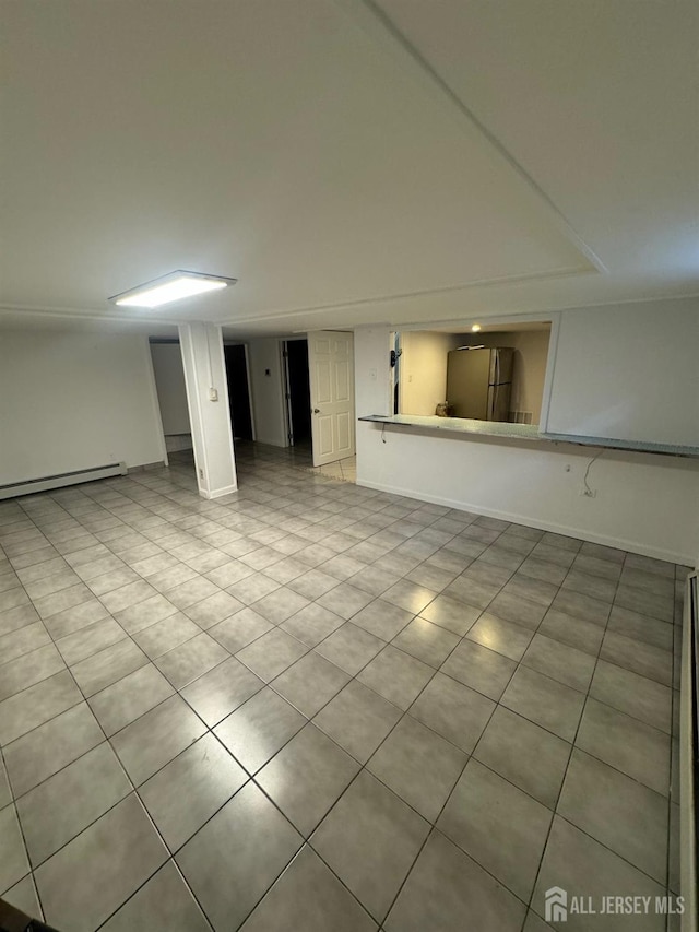 99 Holly St, Port Reading, NJ 07064 - below grade area with freestanding refrigerator, light tile patterned floors, and a baseboard heating unit