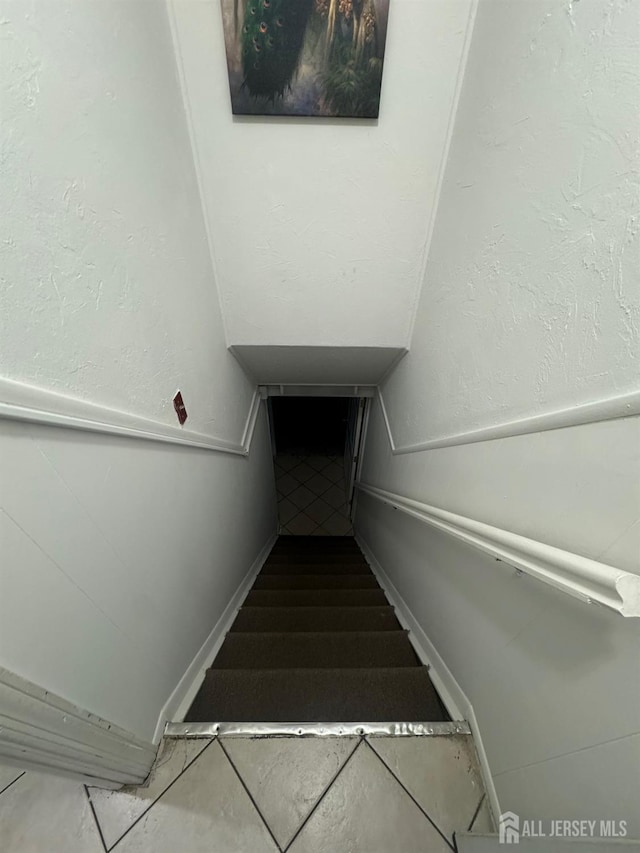 99 Holly St, Port Reading, NJ 07064 - staircase featuring tile patterned floors and baseboards