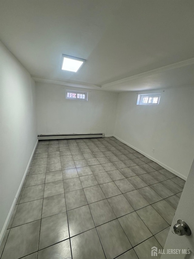 99 Holly St, Port Reading, NJ 07064 - below grade area featuring plenty of natural light, baseboards, and tile patterned floors