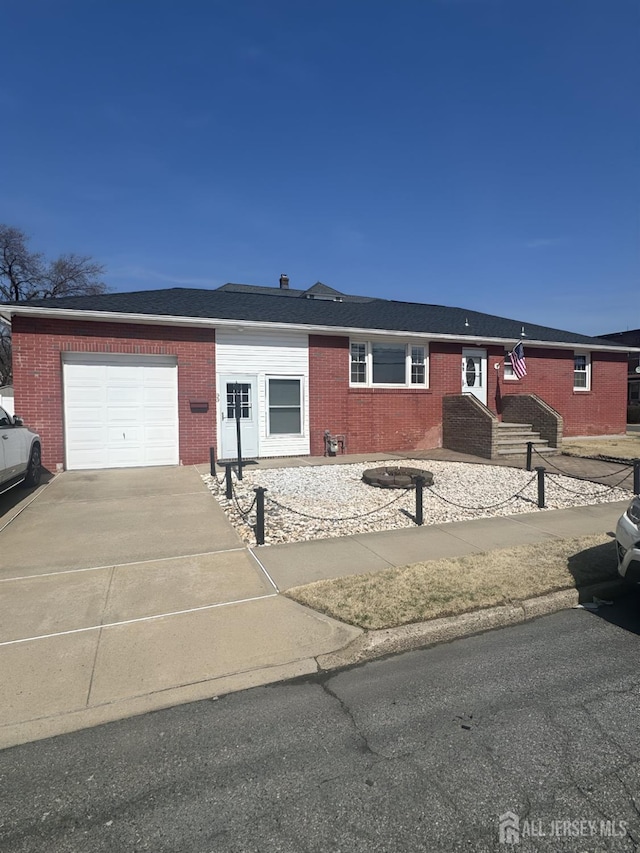 single story home featuring brick siding, an attached garage, and concrete driveway