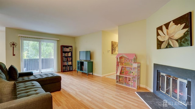 2413 Old Stone Mill Dr, East Windsor, NJ 08512 - living room featuring wood finished floors, a lit fireplace, and baseboards