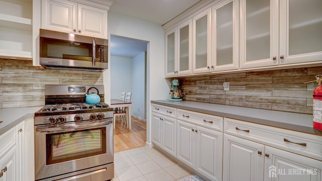 2413 Old Stone Mill Dr, East Windsor, NJ 08512 - kitchen with appliances with stainless steel finishes, decorative backsplash, white cabinets, and light countertops