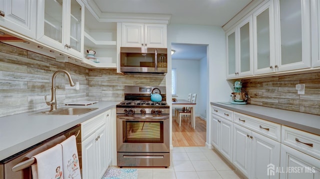 2413 Old Stone Mill Dr, East Windsor, NJ 08512 - kitchen featuring stainless steel appliances, a sink, light countertops, decorative backsplash, and white cabinets