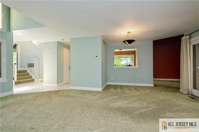 130 Sayre Dr, Plainsboro, NJ 08540 - unfurnished living room featuring carpet, baseboards, stairway, and a chandelier
