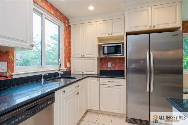 130 Sayre Dr, Plainsboro, NJ 08540 - kitchen with stainless steel appliances, a sink, dark stone countertops, white cabinetry, and wallpapered walls