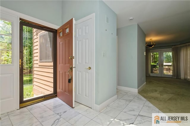 130 Sayre Dr, Plainsboro, NJ 08540 - entryway featuring marble look tiles, baseboards, and french doors