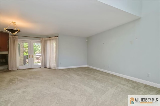 130 Sayre Dr, Plainsboro, NJ 08540 - empty room with french doors, light colored carpet, and baseboards