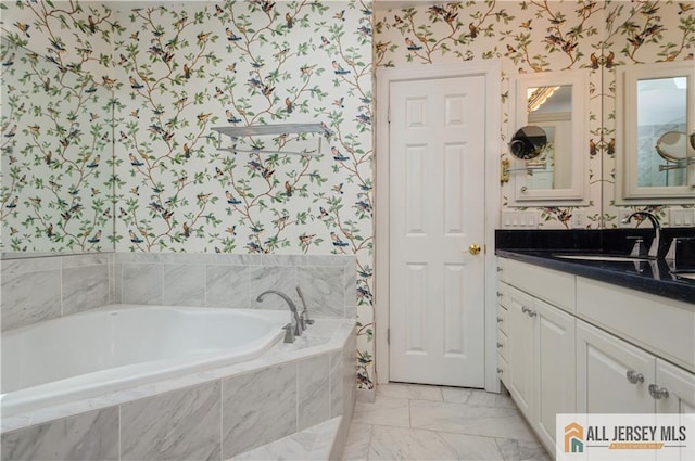 130 Sayre Dr, Plainsboro, NJ 08540 - bathroom with wallpapered walls, vanity, a garden tub, and marble look tile flooring