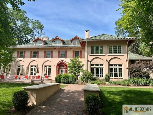 130 Sayre Dr, Plainsboro, NJ 08540 - rear view of house featuring a chimney, a yard, stucco siding, a patio area, and a tiled roof