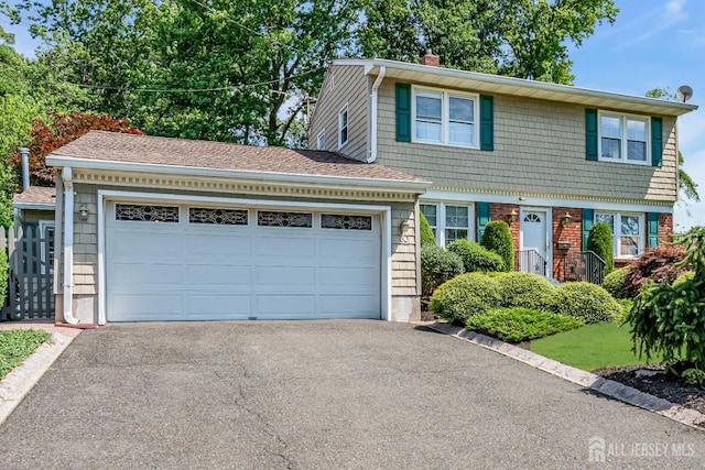 30 Daniel Dr, Matawan, NJ 07747 - view of front of property with asphalt driveway, a chimney, and a garage