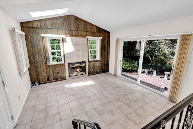 30 Daniel Dr, Matawan, NJ 07747 - unfurnished living room featuring a skylight, lofted ceiling, wood walls, and a fireplace
