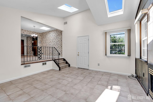 30 Daniel Dr, Matawan, NJ 07747 - spare room featuring a skylight, a chandelier, stairway, and high vaulted ceiling