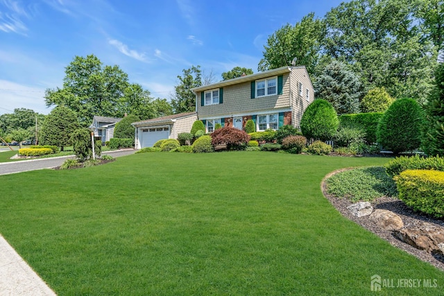 30 Daniel Dr, Matawan, NJ 07747 - colonial-style house featuring an attached garage, a front lawn, and driveway