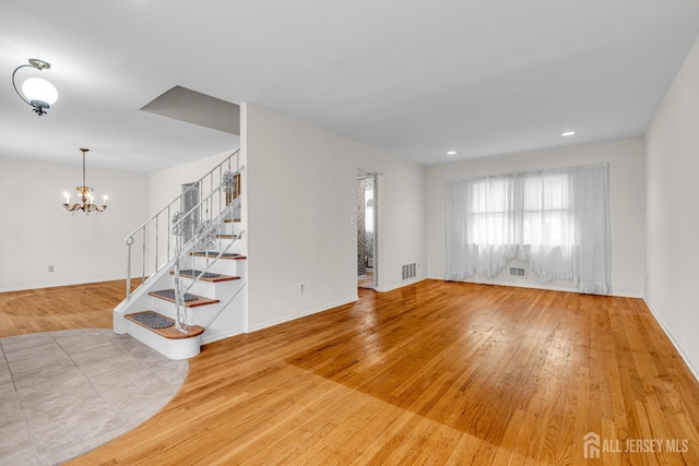 30 Daniel Dr, Matawan, NJ 07747 - unfurnished living room featuring wood finished floors, stairs, a chandelier, and recessed lighting