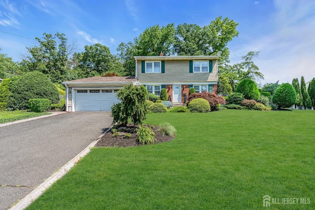 30 Daniel Dr, Matawan, NJ 07747 - colonial house with a garage, a front yard, and driveway