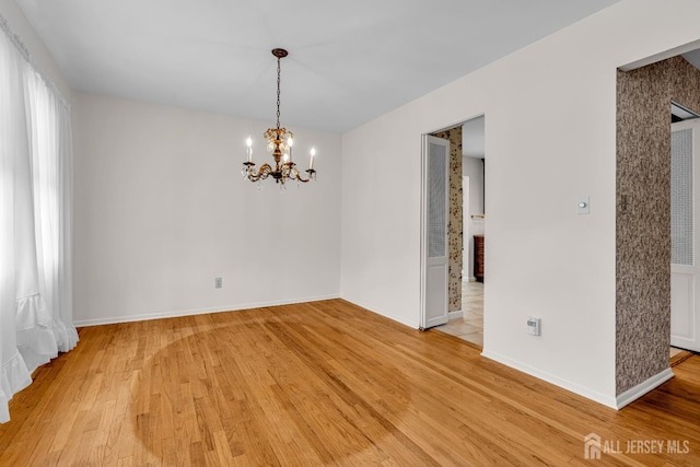 30 Daniel Dr, Matawan, NJ 07747 - spare room featuring a chandelier and light wood-style flooring