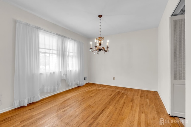 30 Daniel Dr, Matawan, NJ 07747 - spare room with a heating unit, a chandelier, and light wood finished floors