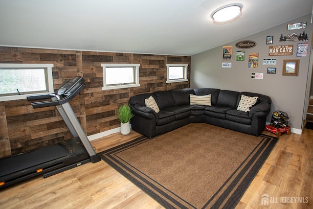 living room with vaulted ceiling and wood finished floors