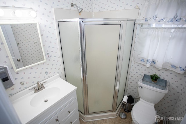 full bathroom with toilet, wallpapered walls, a shower stall, and vanity