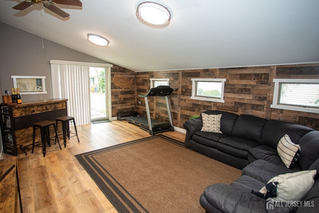 living room featuring vaulted ceiling and light wood-style floors