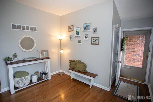 entryway featuring dark wood-style floors, baseboards, and visible vents