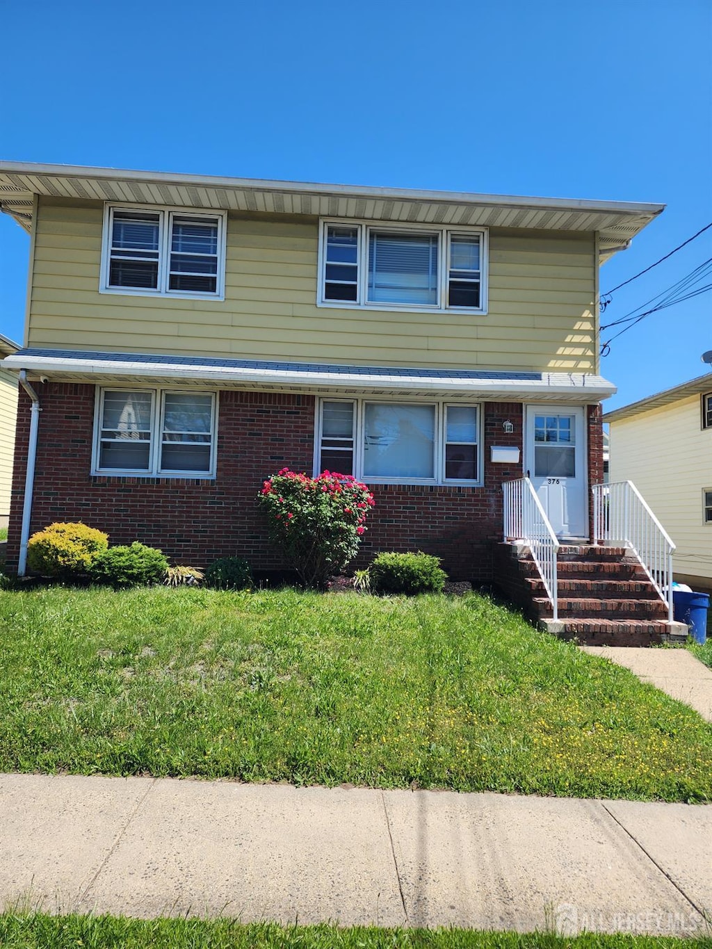 376 Ridgeley St, Perth Amboy, NJ 08861 - view of front of property featuring brick siding and a front yard