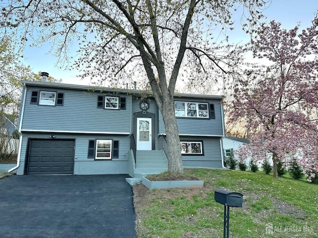 4 Joseph Ct, Old Bridge, NJ 08879 - split foyer home with driveway, a garage, entry steps, and a front lawn