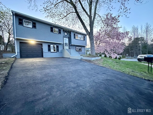 4 Joseph Ct, Old Bridge, NJ 08879 - split foyer home with asphalt driveway and an attached garage