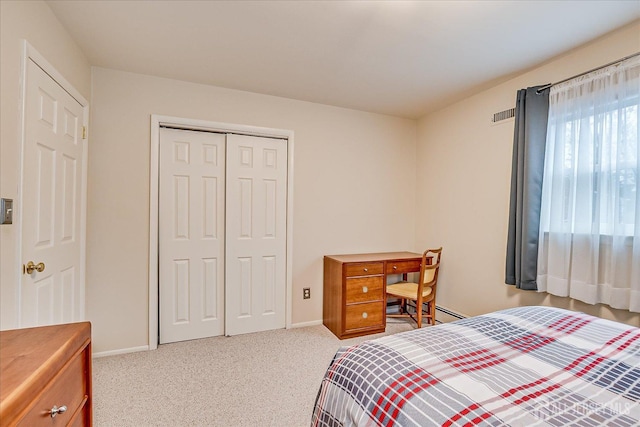 bedroom with visible vents, baseboards, carpet floors, and a closet