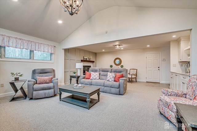 living area featuring high vaulted ceiling, baseboards, light carpet, and recessed lighting