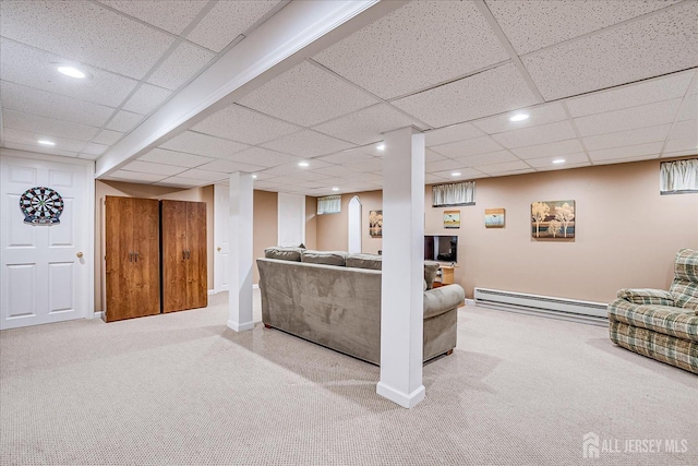 carpeted living room featuring baseboard heating, baseboards, a drop ceiling, and recessed lighting