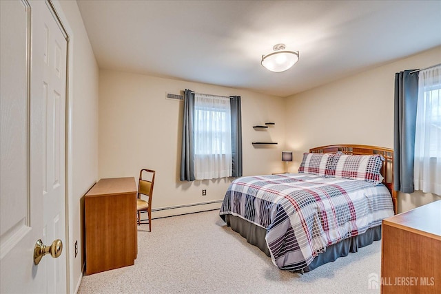 carpeted bedroom featuring a baseboard radiator, baseboards, and multiple windows