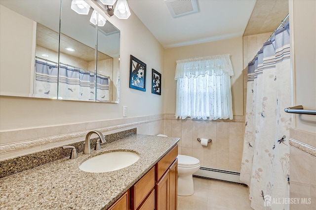 bathroom with tile patterned floors, a baseboard heating unit, vanity, toilet, and visible vents