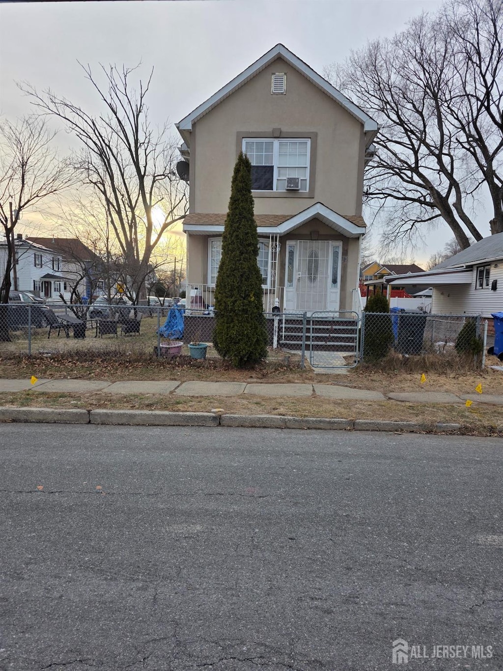 view of front of property with a fenced front yard and stucco siding