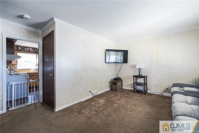 unfurnished living room with ornamental molding and dark colored carpet