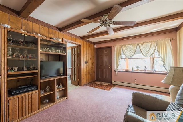 living room with light carpet, wooden walls, beamed ceiling, and a baseboard heating unit