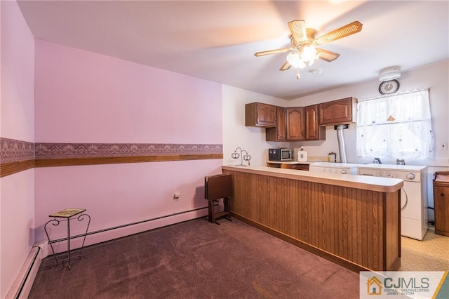 kitchen featuring carpet flooring, kitchen peninsula, sink, and a baseboard radiator