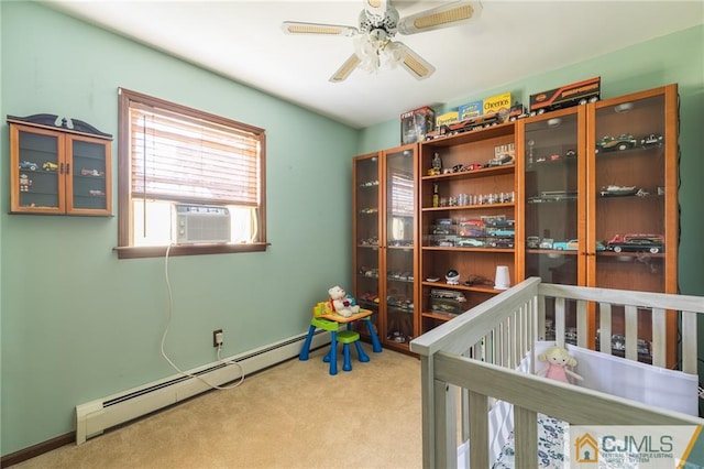 carpeted bedroom featuring ceiling fan, cooling unit, baseboard heating, and a nursery area