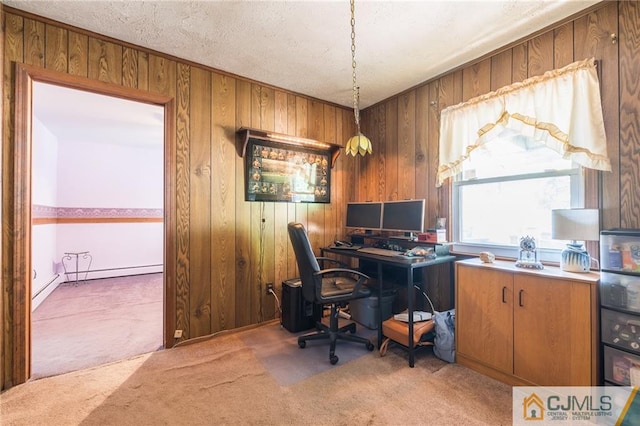 carpeted office with wood walls and a textured ceiling